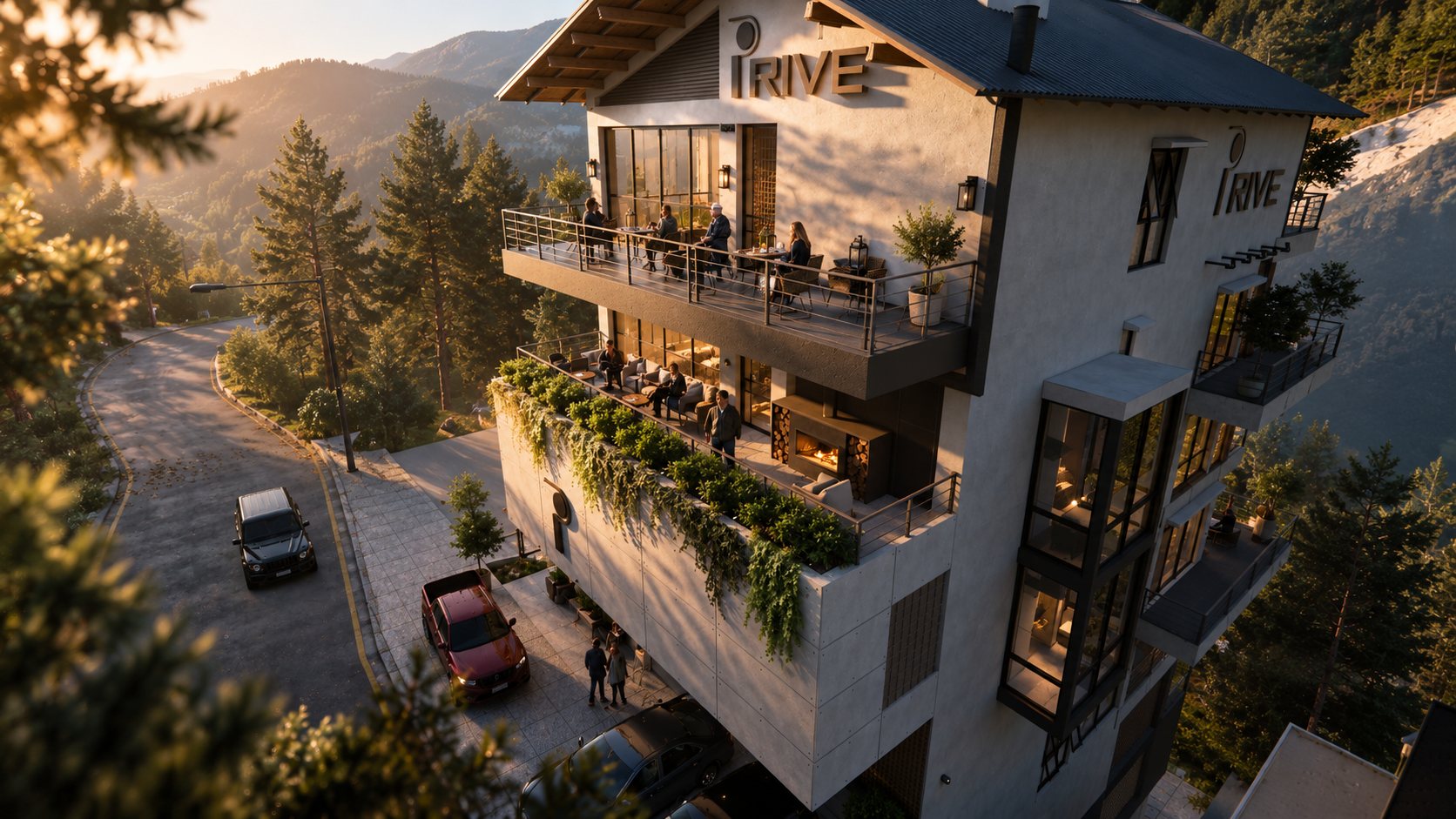 The restaurant terraces seen from above at golden hour, guests at the tables and the fire lit