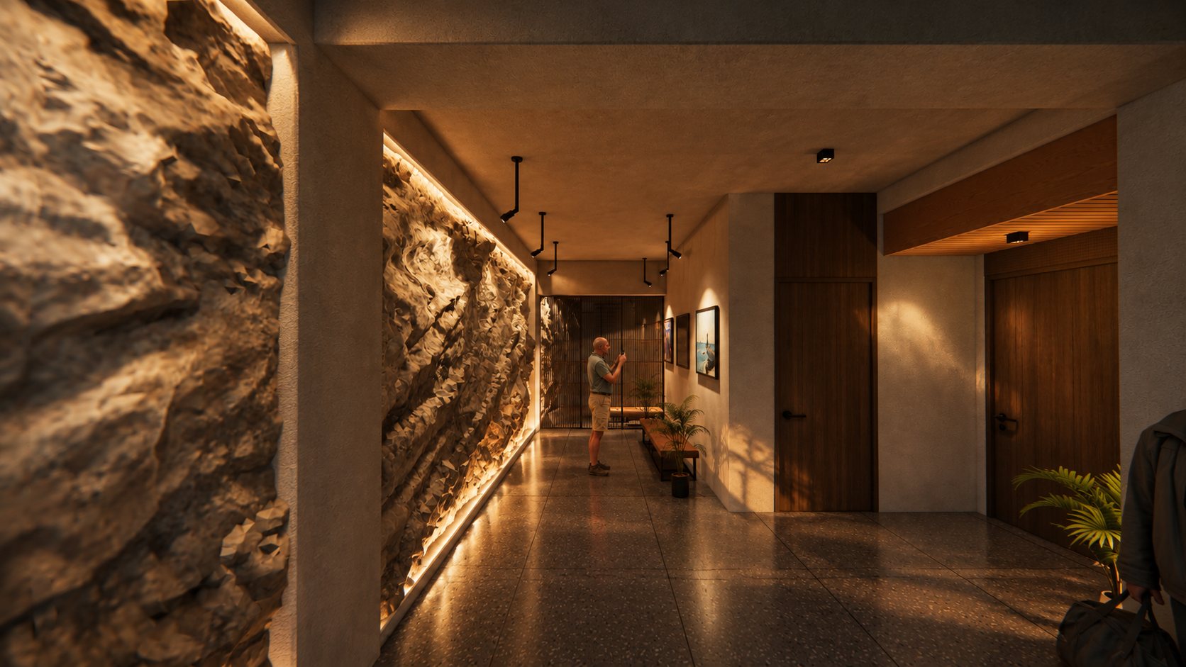 Backlit stone wall running the length of the lower lobby corridor